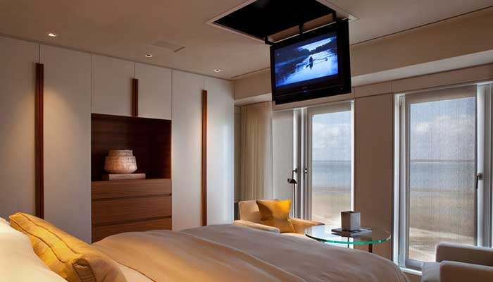 sharp-bedroom-with-big-bed-wardrobe-and-tv-listed-in-also-glass-top-table