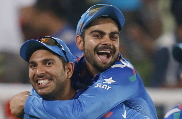 India's Yuvraj Singh, left, carries teammate Virat Kohli on his back as they celebrate their win over Australia in their ICC Twenty20 Cricket World Cup match in Dhaka, Bangladesh, Sunday, March 30, 2014. India won the match by 73 runs. (AP Photo/Aijaz Rahi)