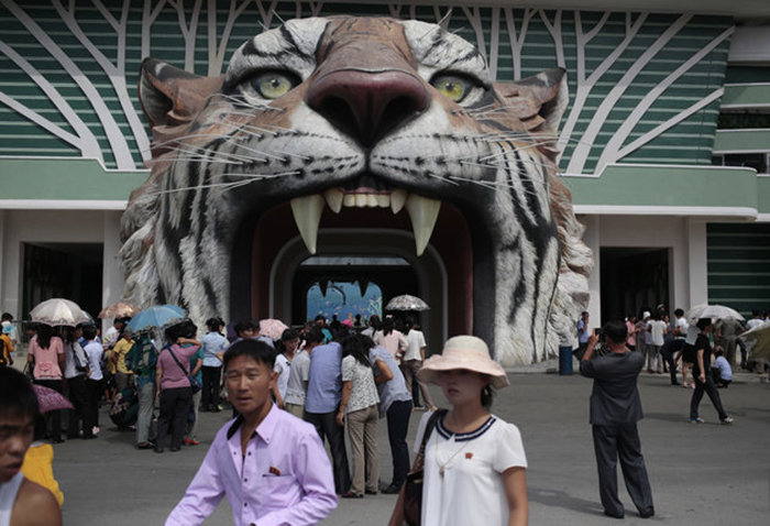 North Koreans wait at the gate of the newly opened Pyongyang Central Zoo in Pyongyang, North Korea, Tuesday, Aug. 23, 2016. North Korean leader Kim Jong Un's latest gift to the lucky residents of Pyongyang, the renovated central zoo, is pulling in thousands of visitors a day with a slew of attractions ranging from such typical zoo fare as elephants, giraffes, penguins and monkeys to a high-tech natural history museum. (AP Photo/Dita Alangkara)